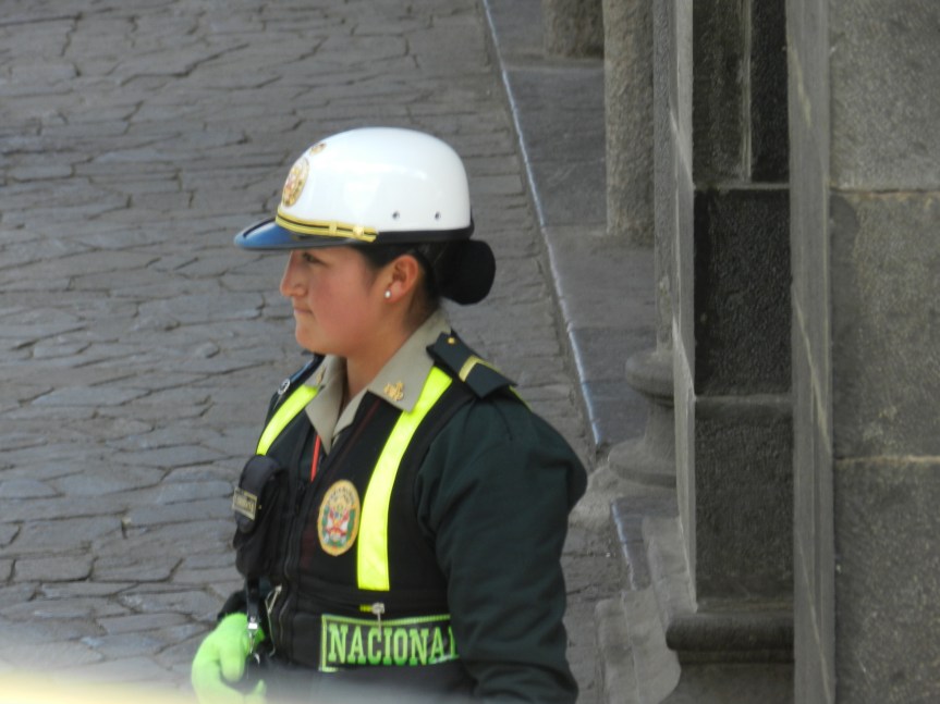 Peruvian Police are sharply dressed and serious.